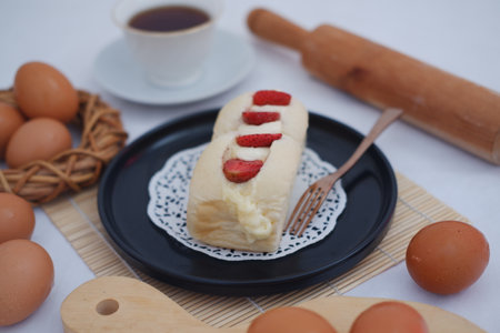 Strawberry cheese cake with cup of coffee on a table.の写真素材
