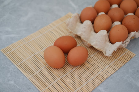 eggs on bamboo mat on a marble backgroundの写真素材