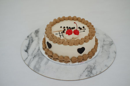 Cake with cherry on top and on a marble background.の写真素材