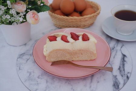 Strawberry cheese cake with cup of coffee on a table.の写真素材