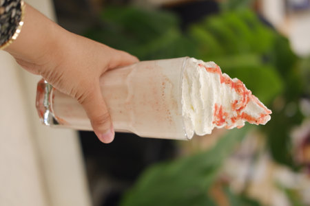 glass of strawberry milkshake with whipped cream.の写真素材