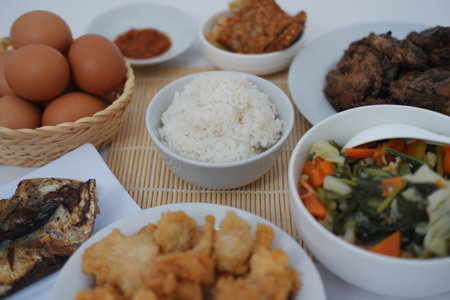 traditional Indonesian food arranged neatly on a white surfaceの写真素材