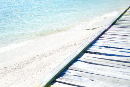 Wooden bridge on the beach with blue sea and sky background.の写真素材