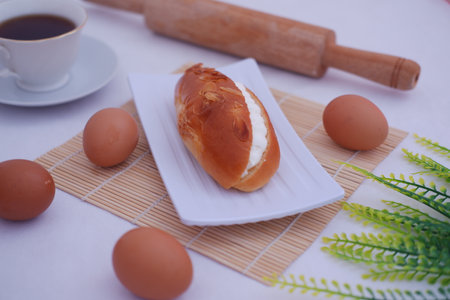 Eclair on a white plate with beautiful decorationの写真素材