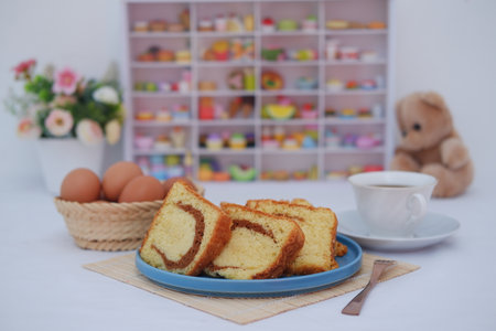sponge cake on a plate and eggs in rattan basket with beautiful decorationの写真素材