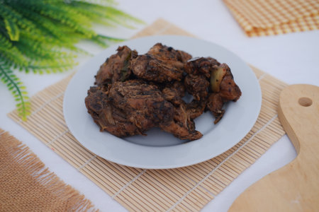 black pepper chicken meat in white plate on bamboo mat.の写真素材