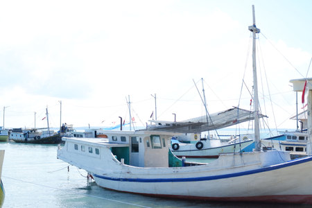Quiet Beach with Traditional Boat and Clear Blue Watersの写真素材