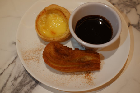 Delicious Dessert Trio with Churros, Custard Tart, and Chocolate Dip