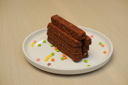 Chocolate bars on a white plate, close-upの写真素材
