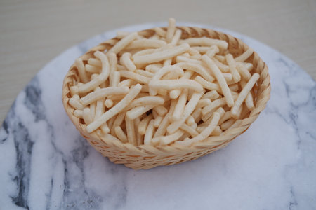 delicious onion flavored snack in rattan basketの写真素材
