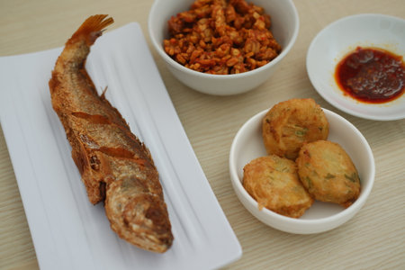 traditional Indonesian food arranged neatly on a wooden surfaceの写真素材
