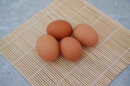 egg on bamboo mat with a marble backgroundの写真素材