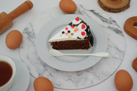 A piece of cake on a plate with white backgroundの写真素材