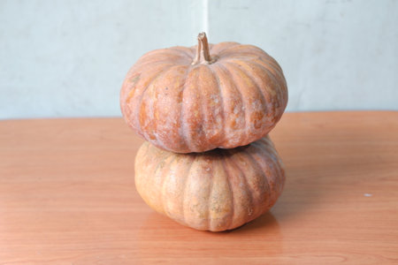 Pumpkin on wooden table with white wall background.の写真素材