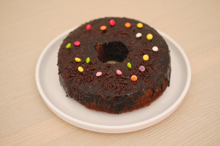 Chocolate cake on plate with wooden backgroundの写真素材