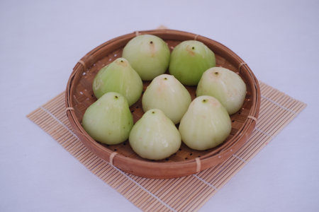 Ripe green apple in rattan basketの写真素材
