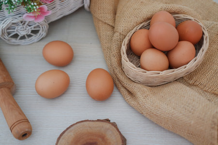 egg on bowl and gunny sack with a wooden backgroundの写真素材