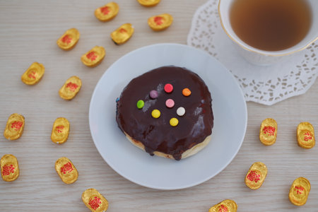 Chocolate Glazed Donut with Colorful Toppings and Tea