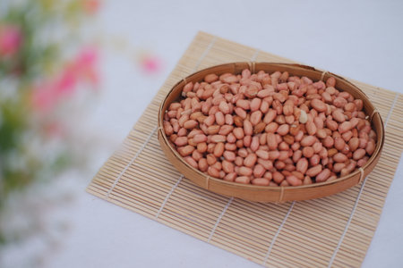 Raw Peanuts in a Traditional Basketの写真素材
