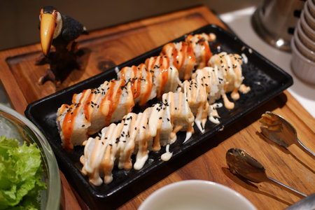 Delicious Sushi Rolls with Tasty Drizzled Saucesの写真素材