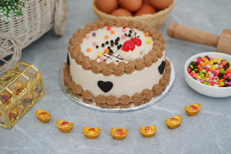 decorated round cake with white and light brown frostingの写真素材