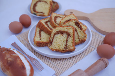 a plate of sliced marble cake with a golden brown crust and a softの写真素材