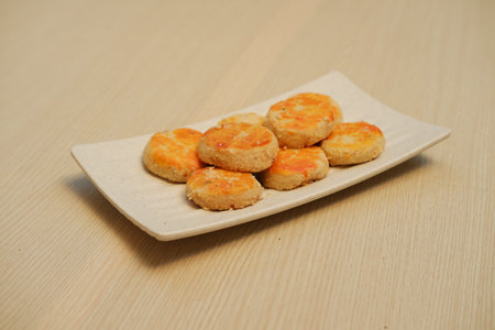 seven round cookies or pastries with a golden brown topの写真素材