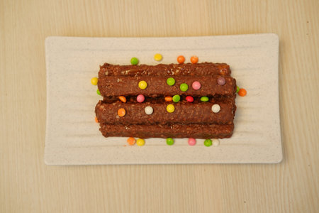 The chocolate bars appear rich and textured, possibly containing nuts or crispy riceの写真素材
