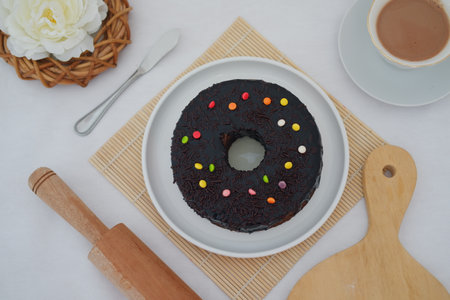 a beautifully presented chocolate donut cake placed on a white plateの写真素材