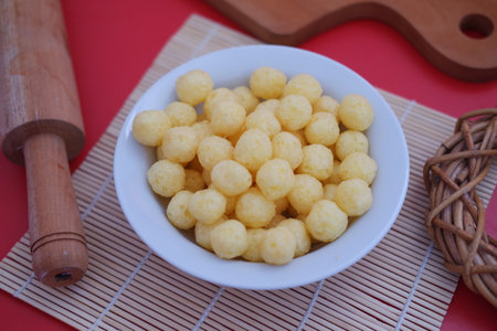 These snacks are light, crunchy, and typically have a cheesy or savory flavorの写真素材
