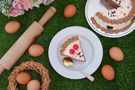 Delicious cake and eggs on green surfaceの写真素材