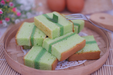 Delicious Pandan Layer Cake Slices on a Wooden Trayの写真素材