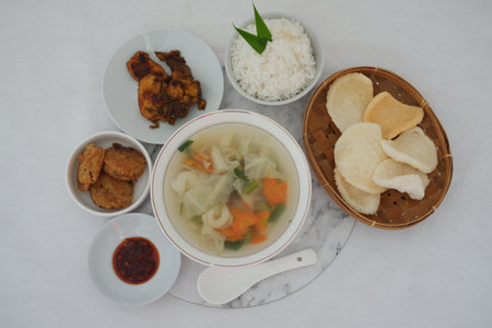 Delicious Indonesian Meal Soup, Rice, Chicken, and Sidesの写真素材