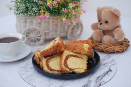 Delicious marble cake slices with tea and teddy bearの写真素材