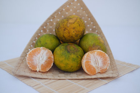 Vibrant pile of mandarins, showcasing fresh citrus fruits and peeled segmentsの写真素材