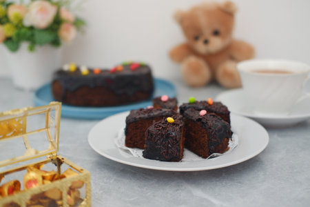 Delicious Chocolate Cake Slices with Sprinkles and a Teddy Bearの写真素材