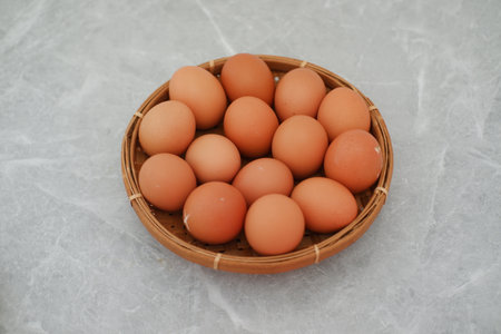 Organic Brown Eggs on Bamboo Plateの写真素材