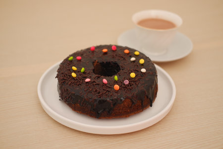Chocolate Donut with Colorful Sprinkles and Hot Cocoaの写真素材