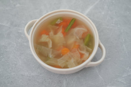 Vegetable Soup in White Bowl on a Gray Surface