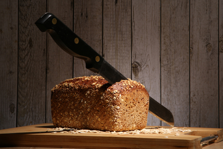 Loaf of bread with a knife stuck in itの写真素材