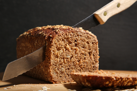 Detail of sliced bread loaf in front of slate background