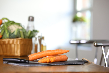 Sliced carrots on a slate in the kitchenの写真素材