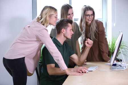 Friends at work togetherの写真素材