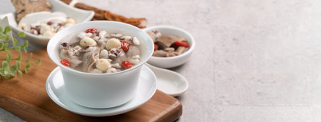 Four Tonics Soup. Close up of delicious homemade Taiwanese traditional Chinese herb flavor food with herbs, pork intestine on gray table backgroundの写真素材