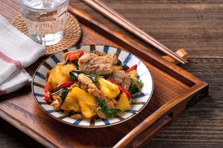 Stir-fried Taiwanese Three Cup Chicken with pineapple. Homemade delicious food in Taiwan on dark...
