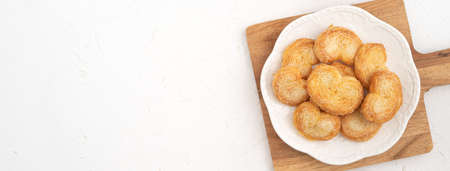 Top view of delicious Palmier butterfly puff pastry cookie in heart shape for Valentine's day dessert concept.の写真素材