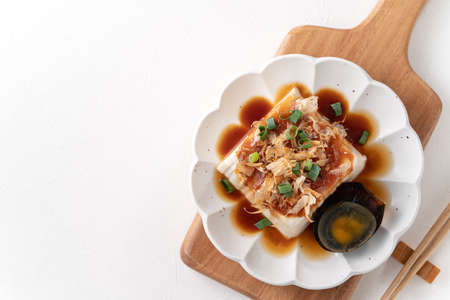 Top view of delicious Chilled tofu and century egg food with soy sauce and bonito flakes topping in...