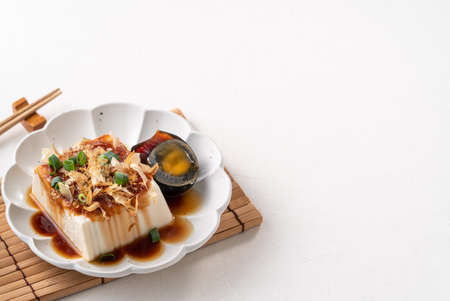 Delicious Chilled tofu and century egg food with soy sauce and bonito flakes topping in Taiwan.の写真素材