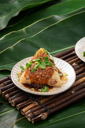 Vegetable zongzi. Vegetarian rice dumpling for traditional Chinese Duanwu Dragon Boat Festival food with glutinous rice, peanuts, and coriander.の写真素材