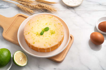 Delicious Lemon Glazed Pound Sponge cake in a plate on white marble table background.